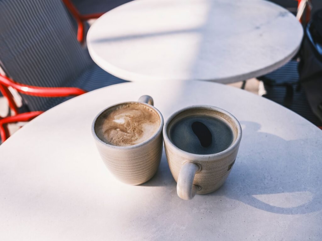 Twee koppen koffie op een cafétafel tijdens een eerste respectvolle ontmoeting in Andenne